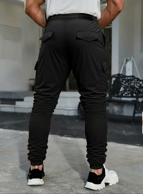 Men's solid color tactical work pants with multiple pockets and drawstring design