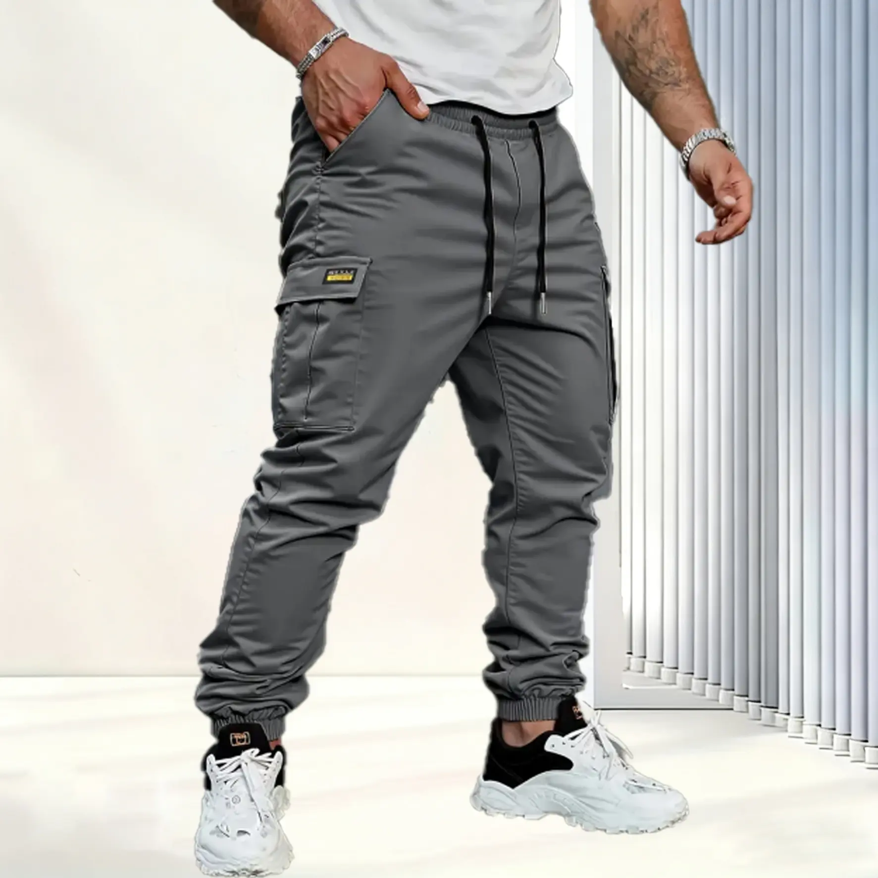 Men's solid color tactical work pants with multiple pockets and drawstring design
