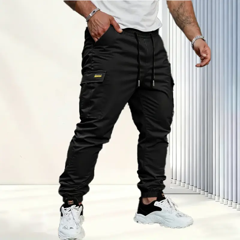 Men's solid color tactical work pants with multiple pockets and drawstring design