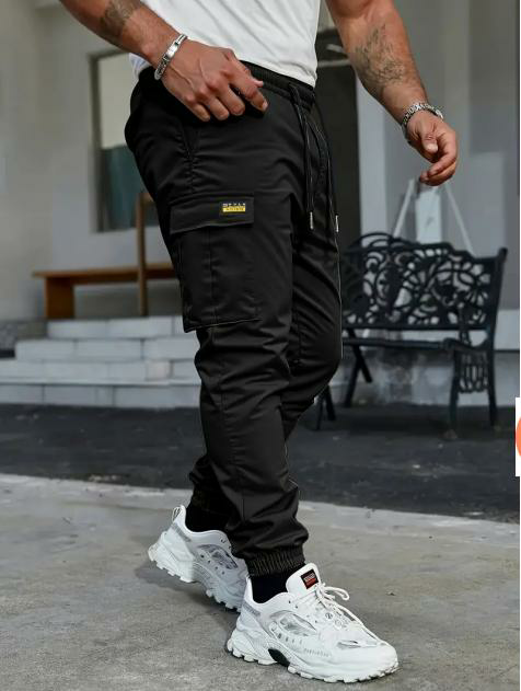 Men's solid color tactical work pants with multiple pockets and drawstring design