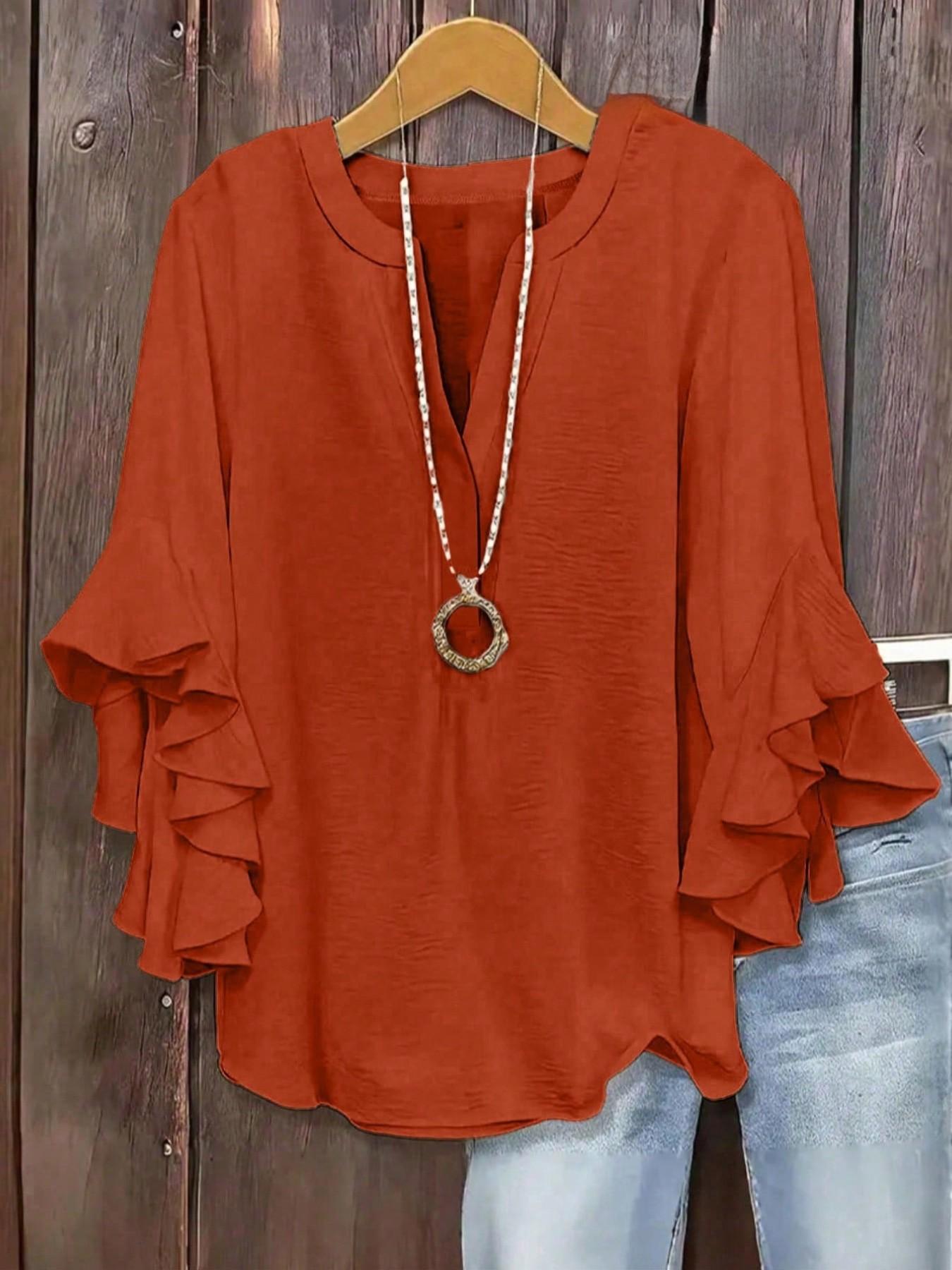 Plus-size women's V-neck blouse with ruffle sleeves and an elegant floral print