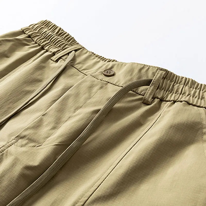 Men's casual cargo shorts featuring zippered pockets and a button fly.