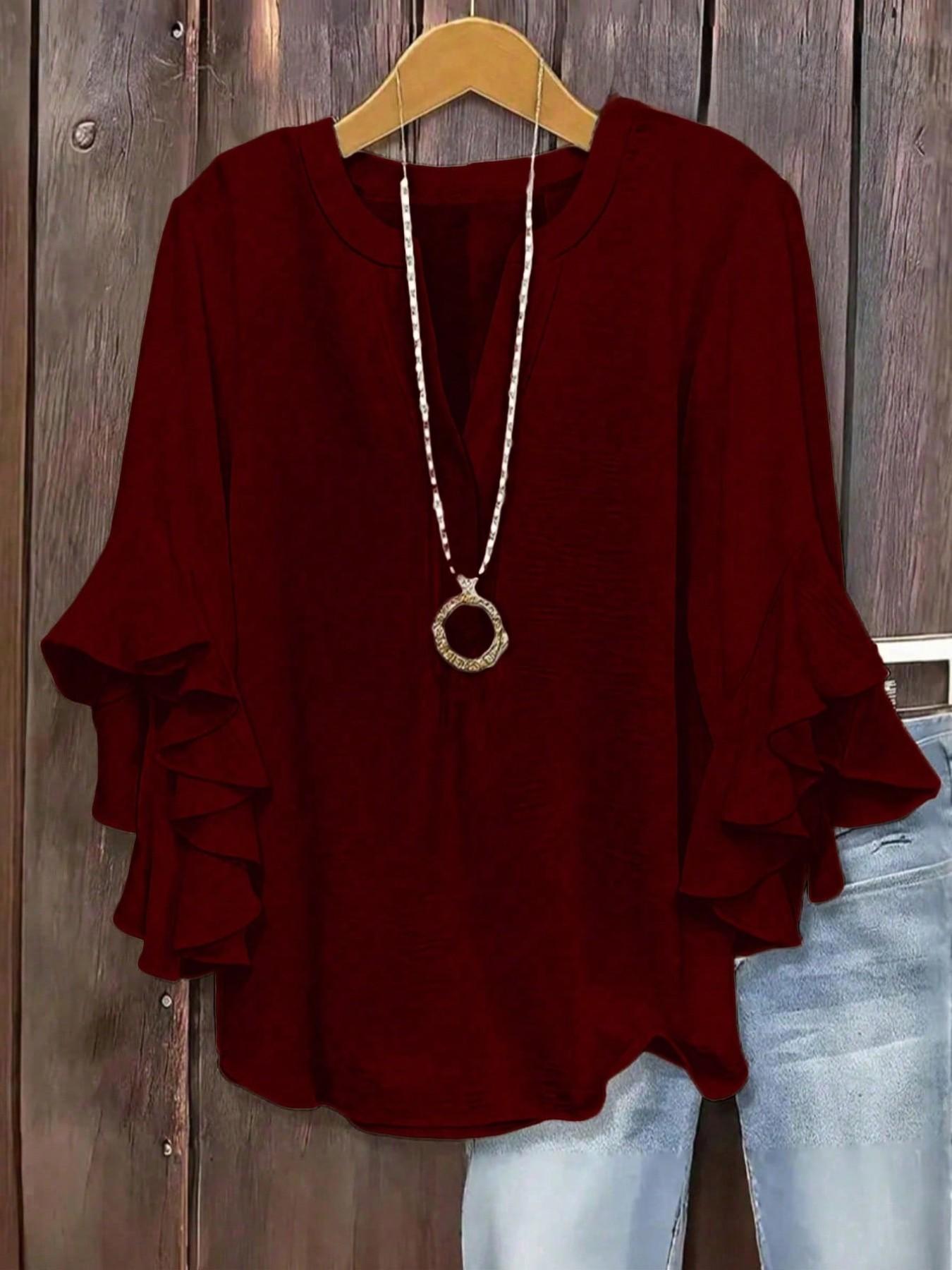 Plus-size women's V-neck blouse with ruffle sleeves and an elegant floral print