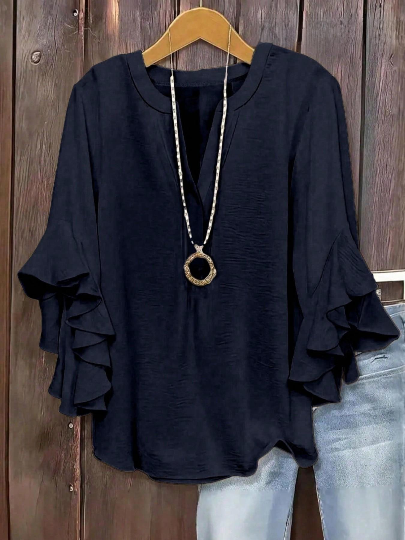 Plus-size women's V-neck blouse with ruffle sleeves and an elegant floral print
