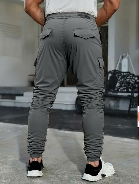 Men's solid color tactical work pants with multiple pockets and drawstring design
