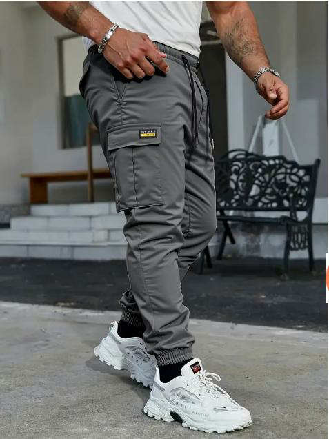 Men's solid color tactical work pants with multiple pockets and drawstring design